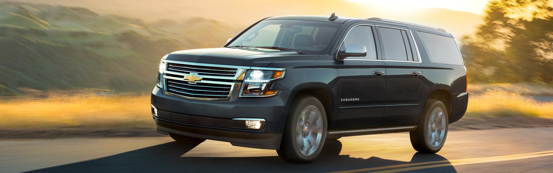 Photo of a Chevrolet Suburban vehicle driving on the road