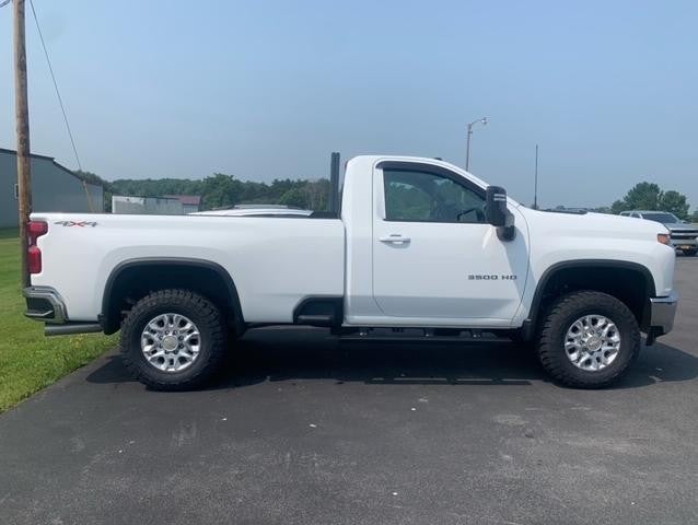 Side view of white Chevy 2500 HD truck showing trim accessories from Rough Country and Fuel Accessories | Parkway Chevrolet | CANTON, NY